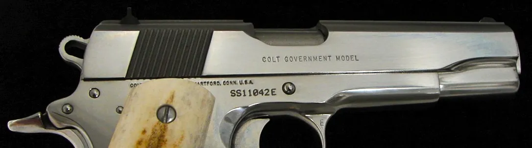 Colt Government .45 ACP caliber pistol. Series 80 bright stainless model with genuine stag grips. Near excellent condition with (C6369)