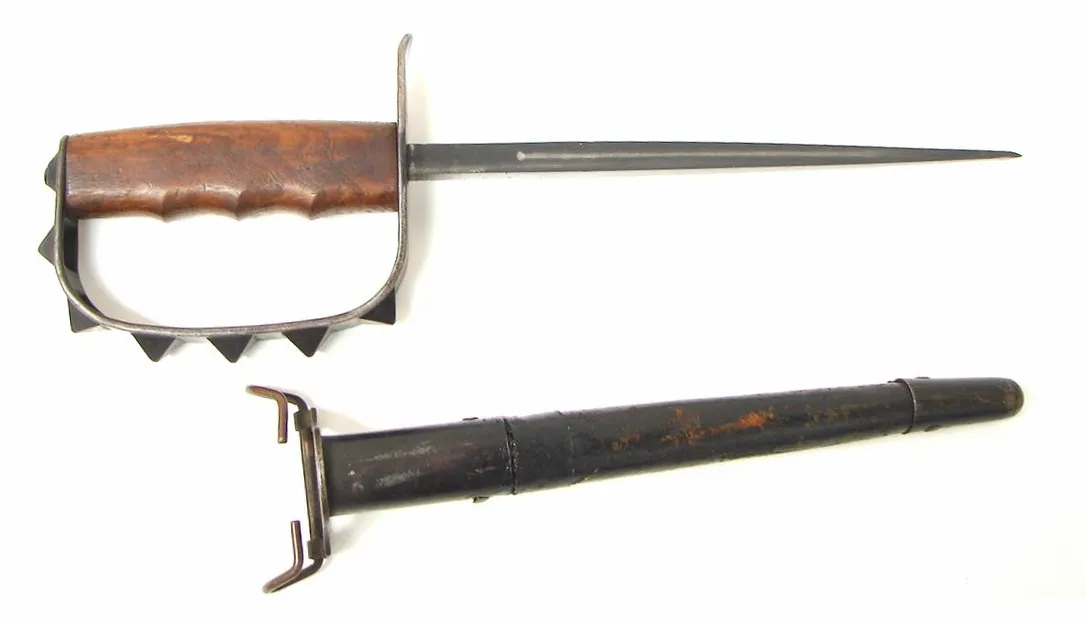 U.S. Army World War I Trench Knife by L.F.&C. Dated 1917. Scabbard is solid and has an old repair near the metal sleeve. (MEW1302)